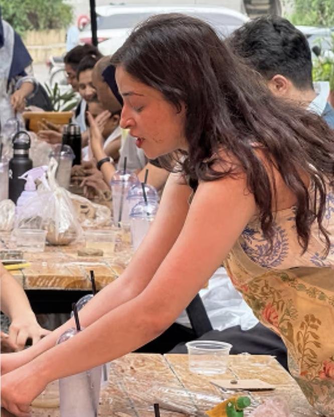 Fatima leading a ceramics workshop